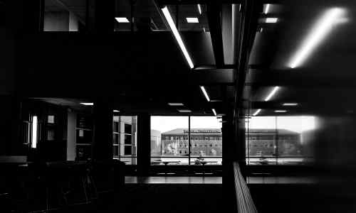 A black and white photo of a classroom in Cook-DeVos where Finkelstein is visable through the window. 